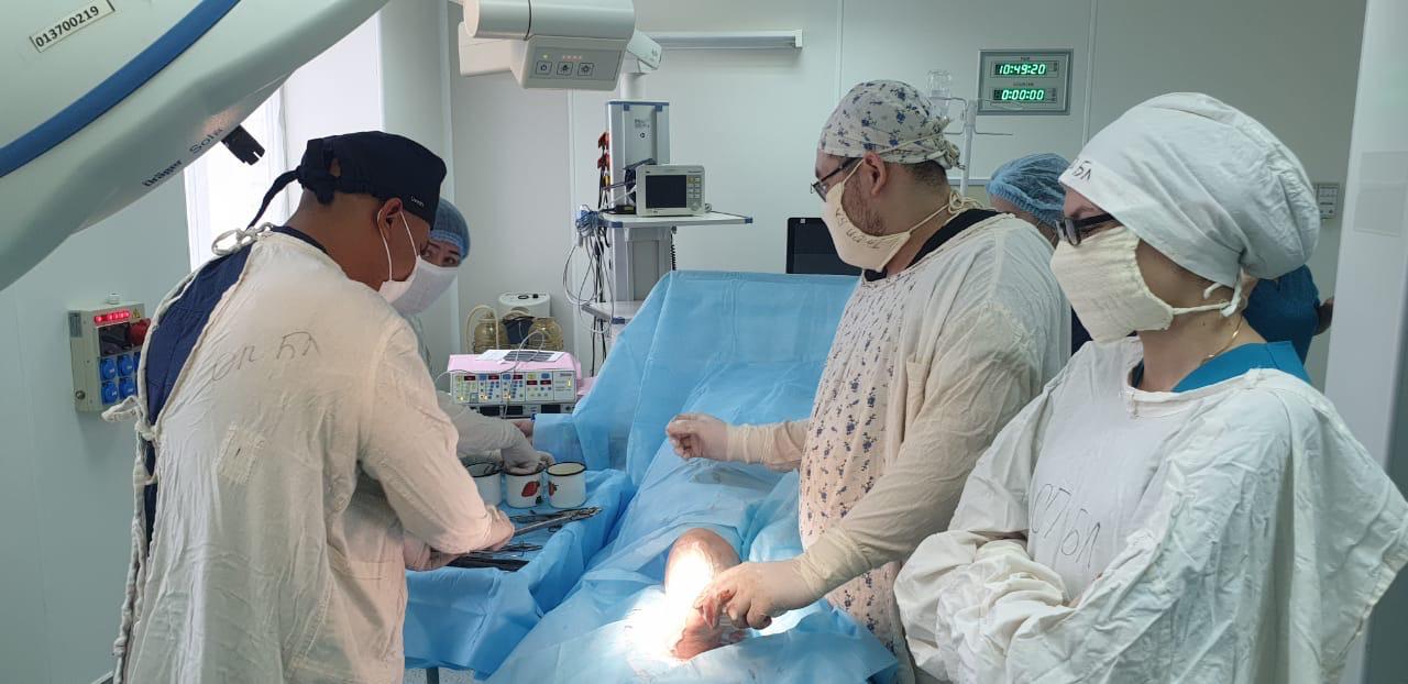 Dr. Anil Sharma treating a patient with the surgical team in an operating room